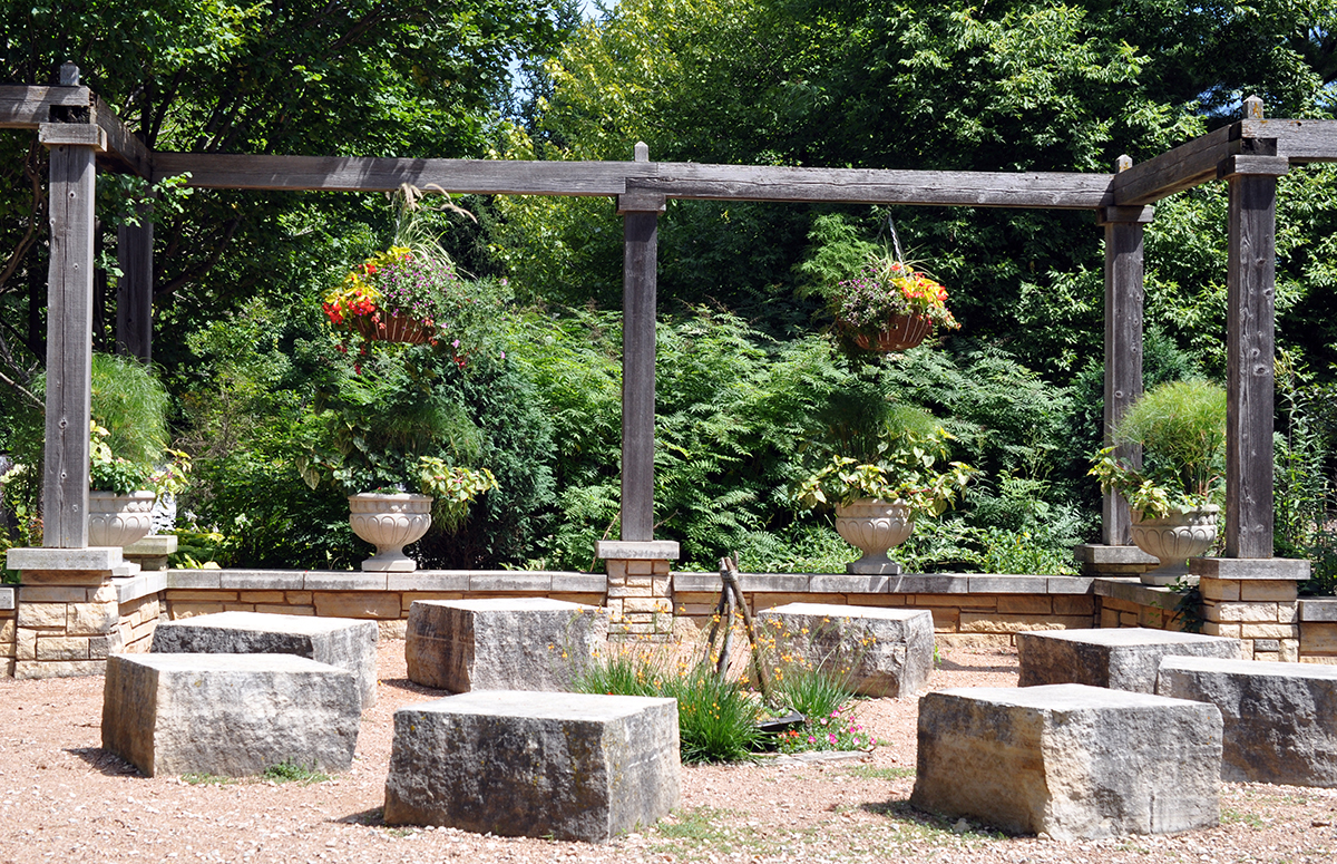 Prairie Vista Garden with gravel, limestone blocks, wood structure with hanging baskets