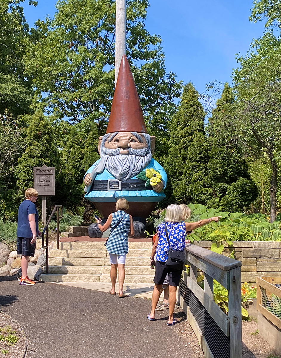 Reiman Gardens Elwood the World's Tallest Concrete Gnome in summer with people standing around
