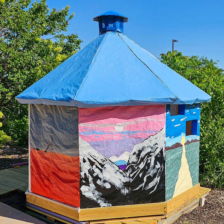 Octagonal playhouse painted with nature scenes