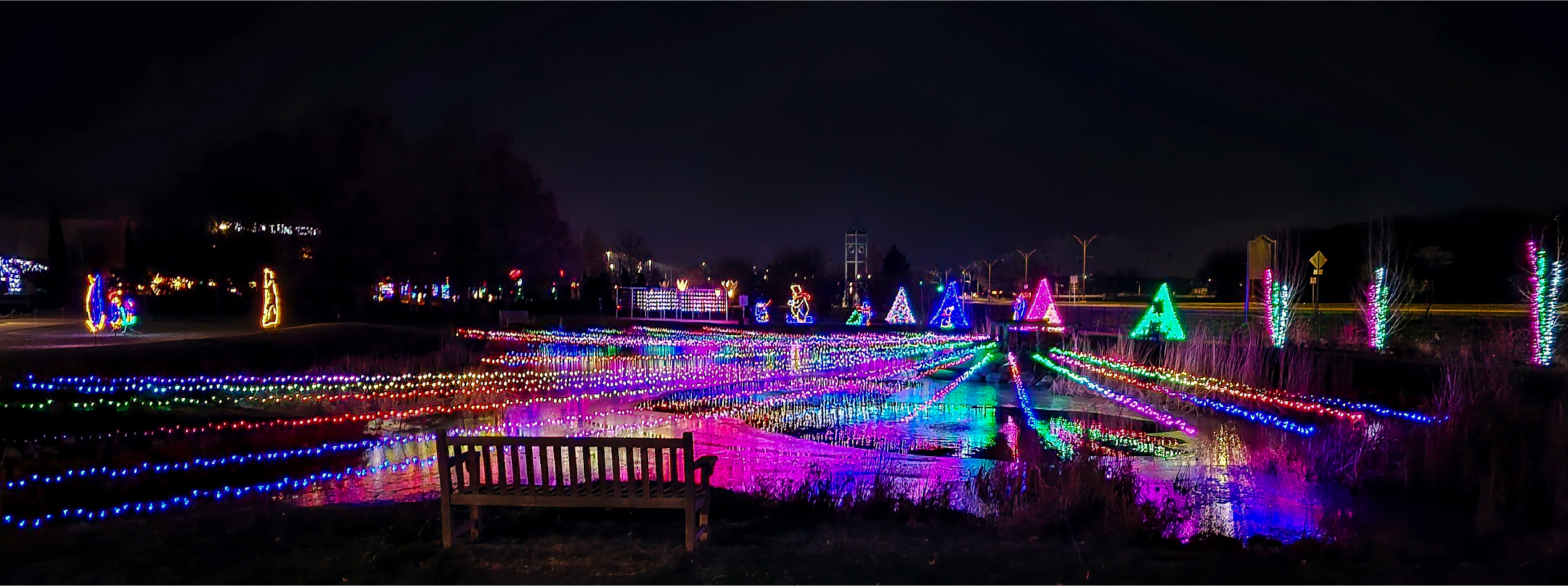 Colorful lights suspended over a lake