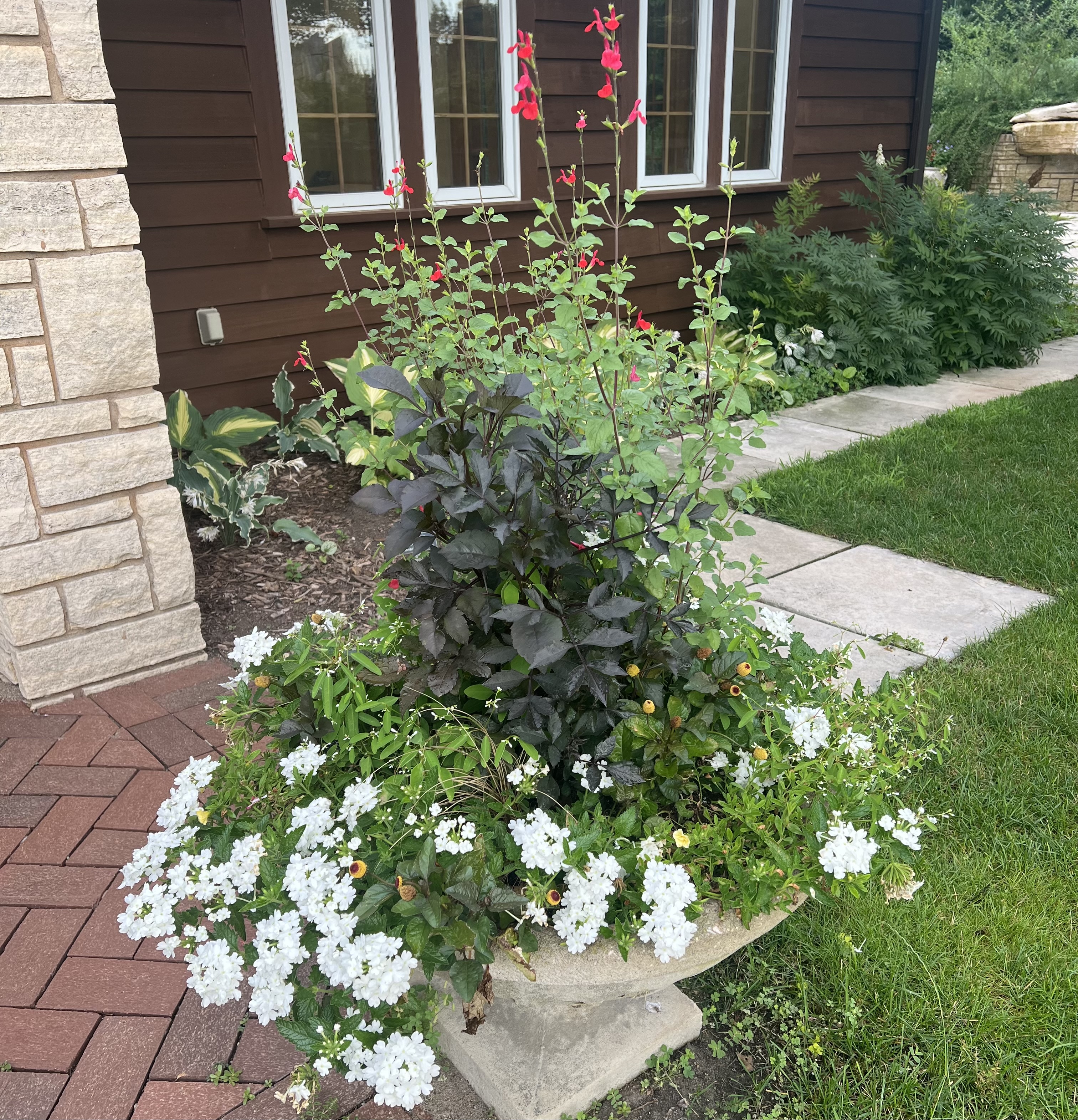 stone containers with lush foliage and flowers