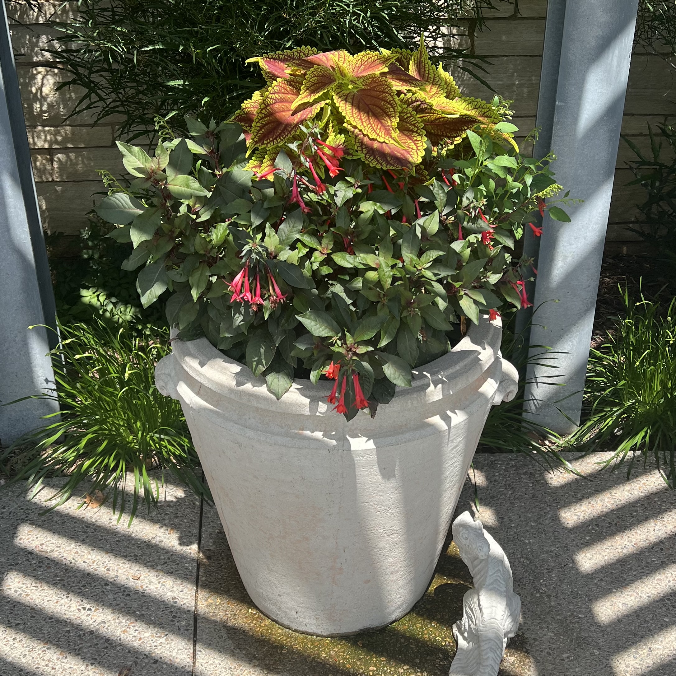A stone container with bright foliage and flowers
