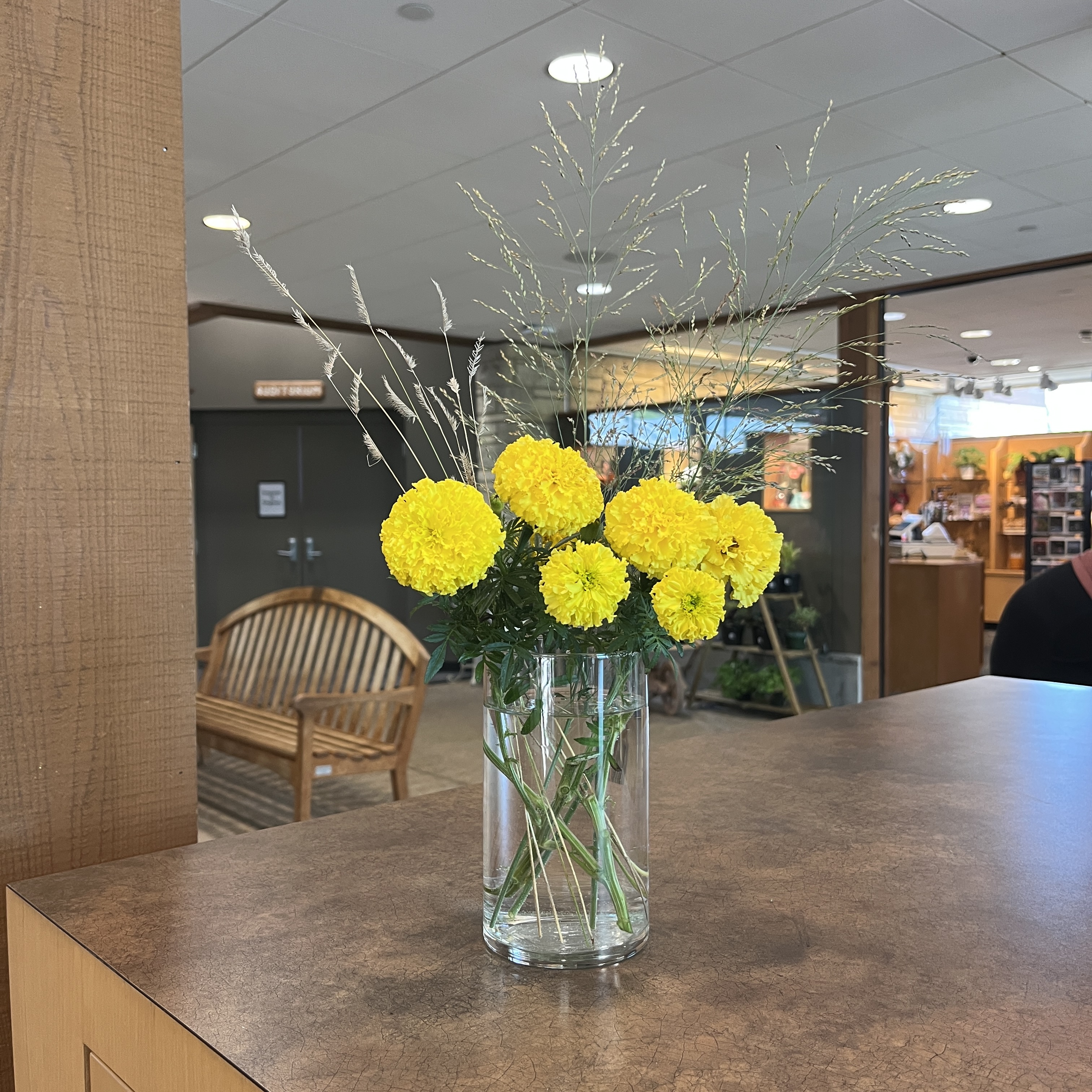 Bouquet of yellow flowers and grasses.
