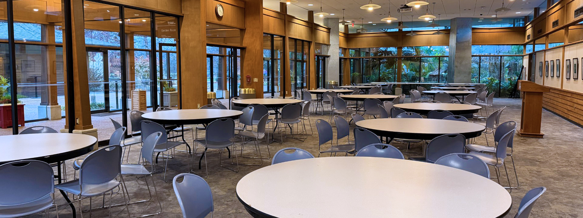 round tables in a large room with tall windows