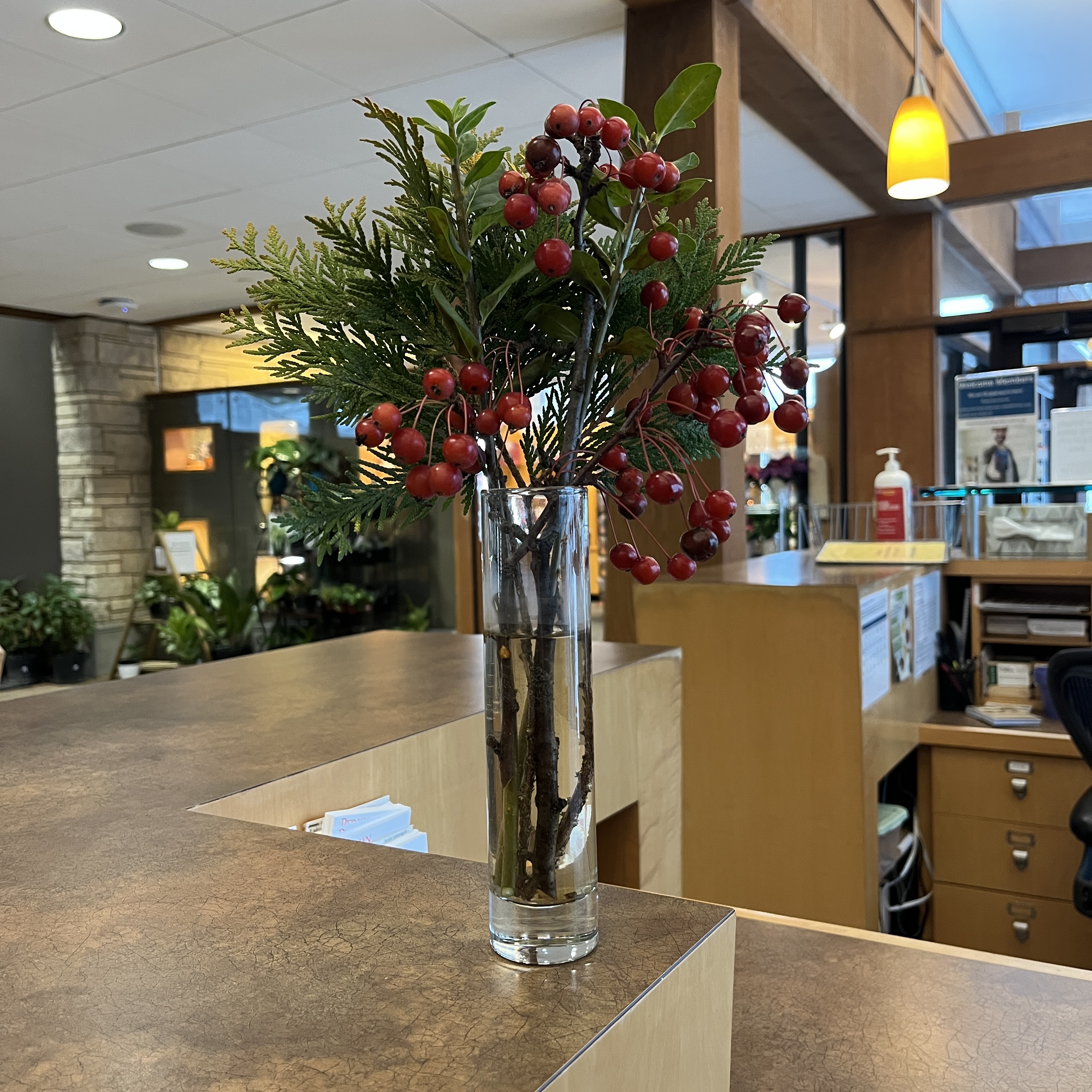 Bouquet with red berries and green foliage. 