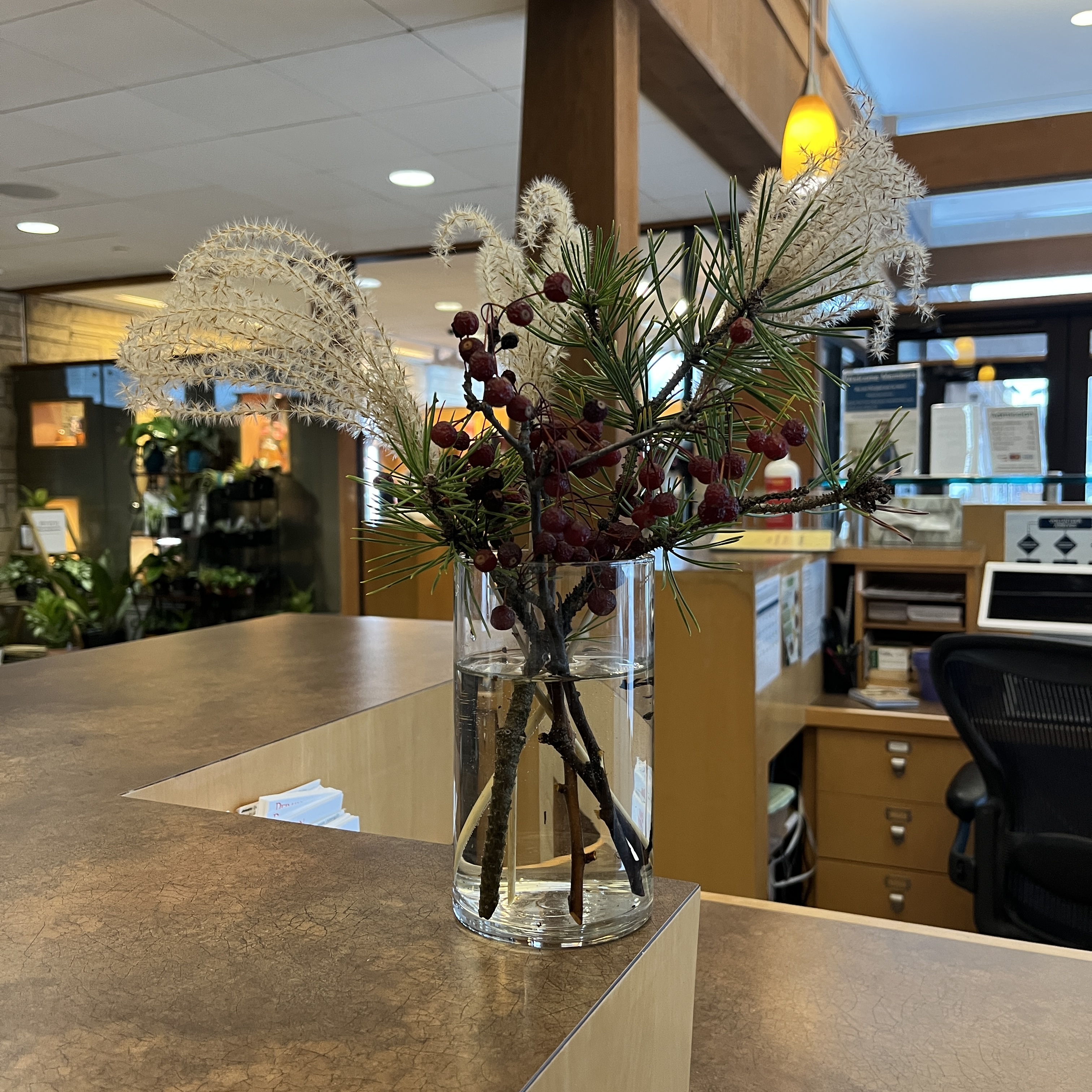 Bouquet with grasses, pine, and berries. 