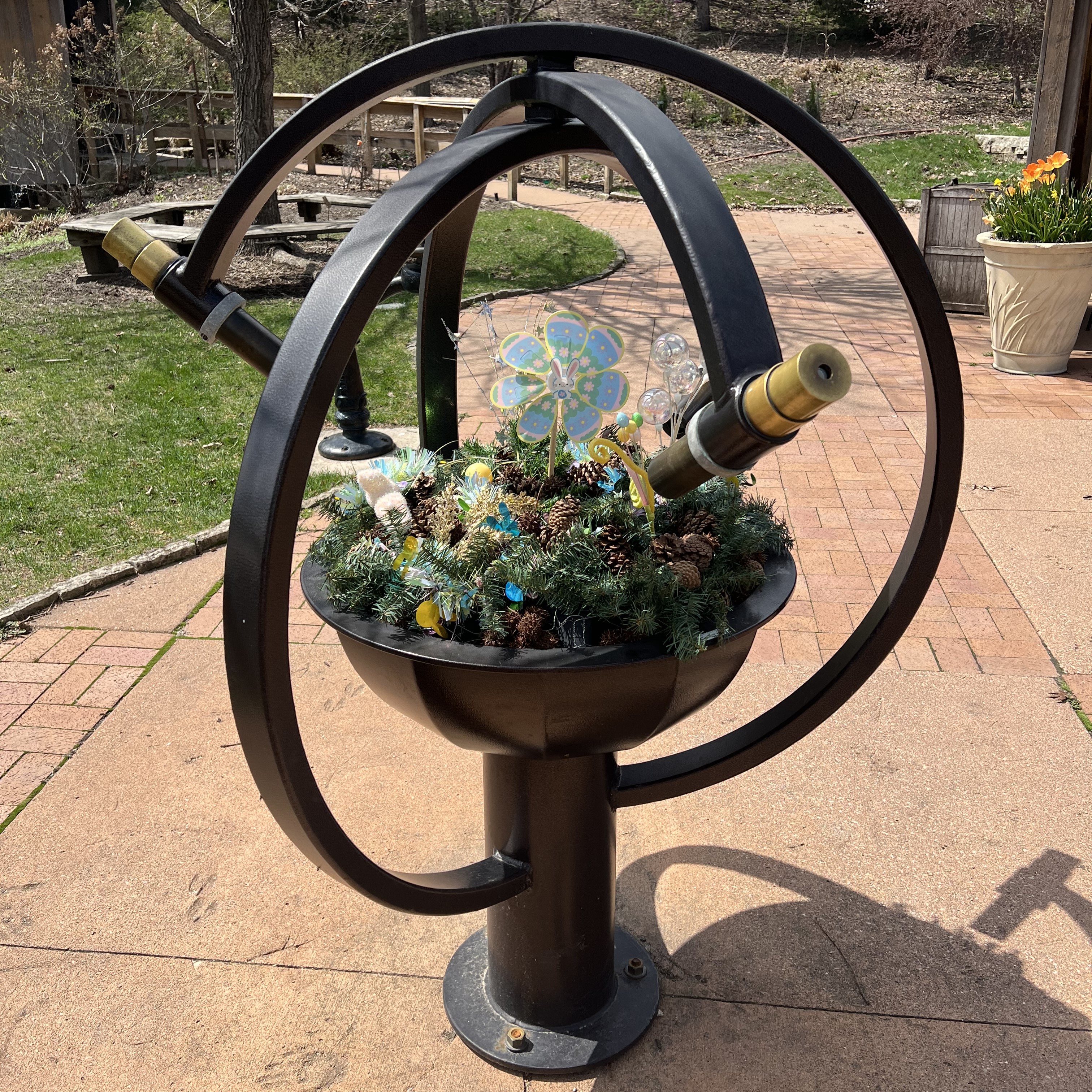 a large telidoscope with a spinning planter in the middle
