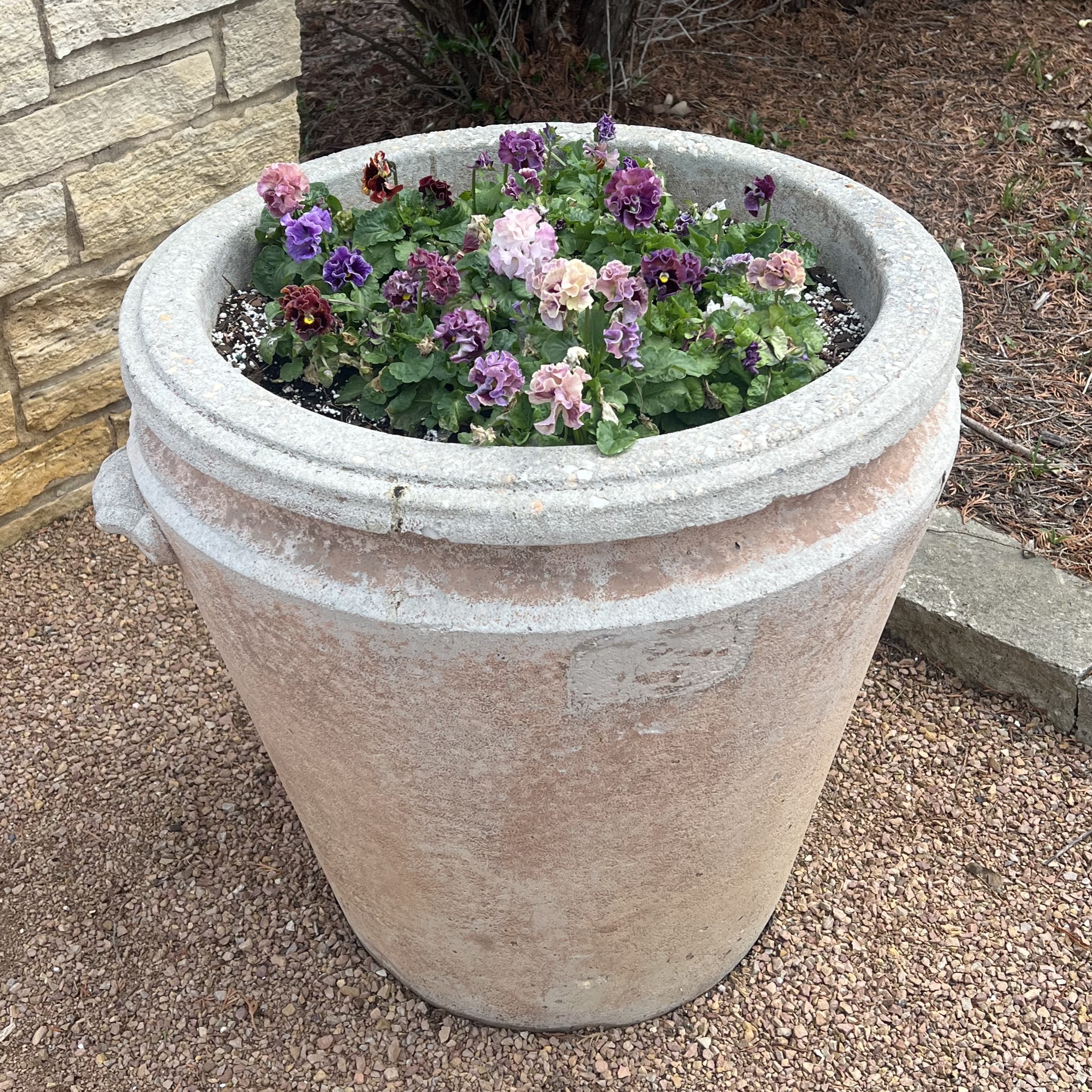 medium sized stone container with pansies