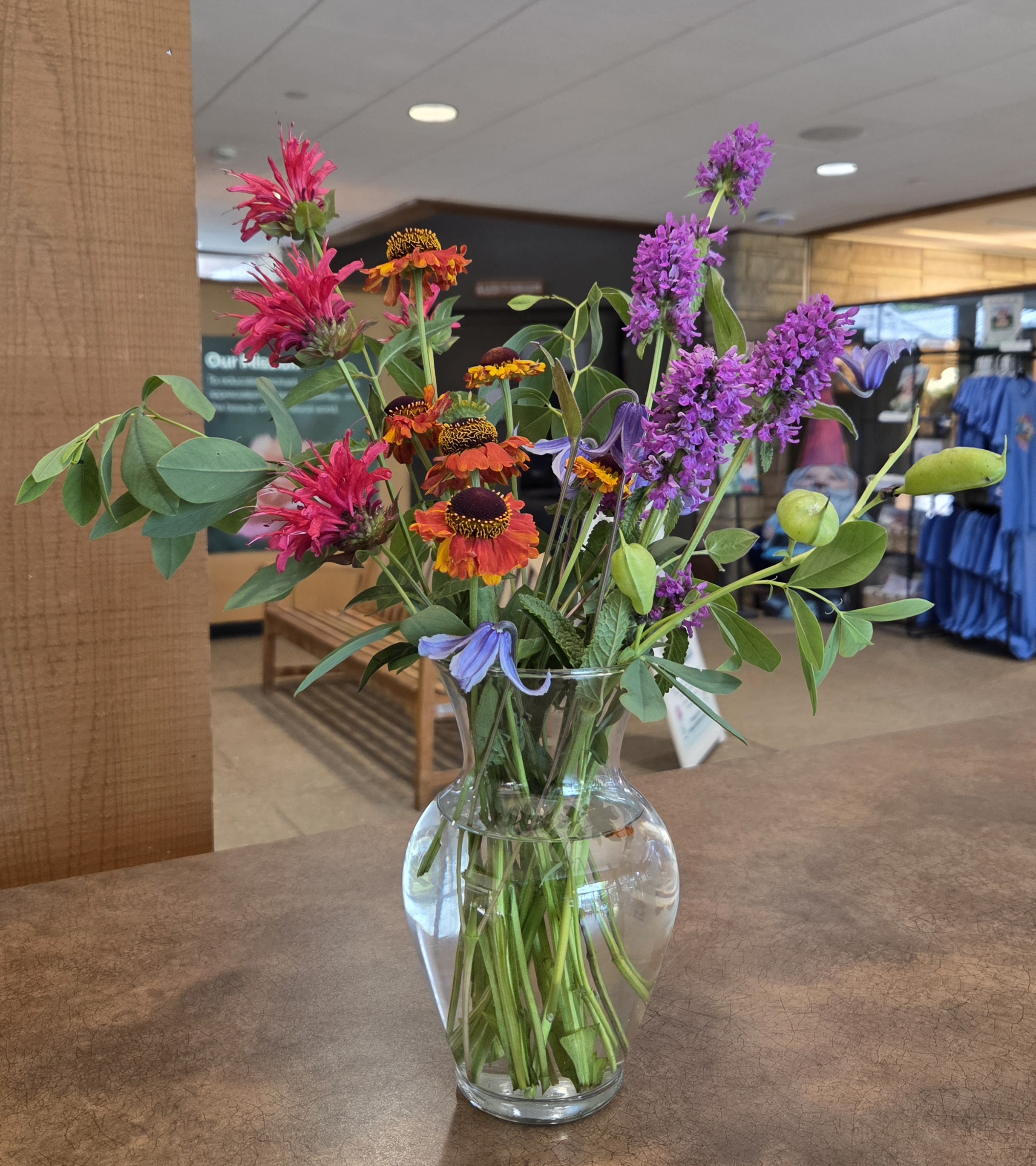 A floral arrangement with Bee Balm, Sneezeweed, Baptisia, Clematis, and Betony