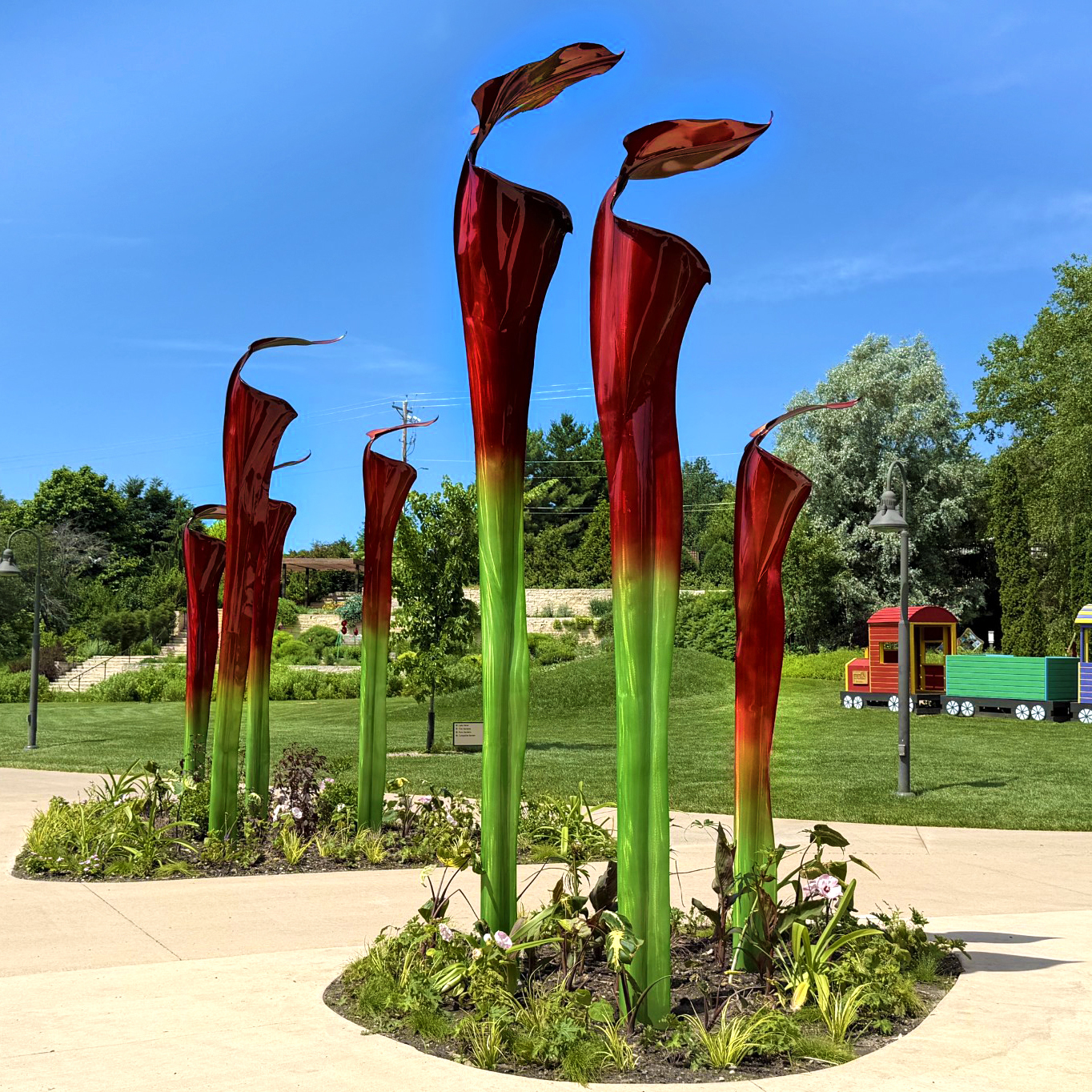 Giant trumpet pitcher plant sculptures in a garden 