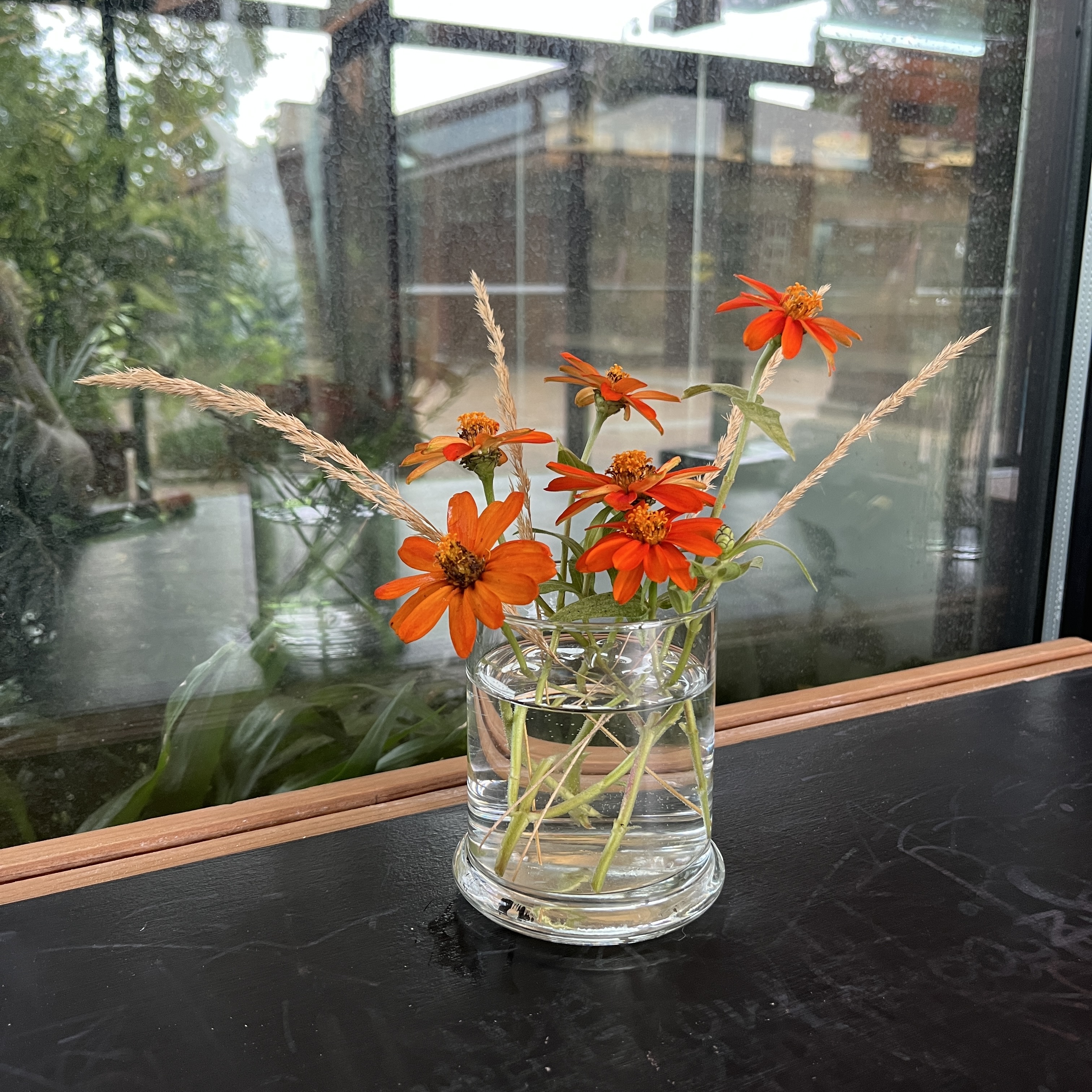 Bouquet with grass and orange flowers.