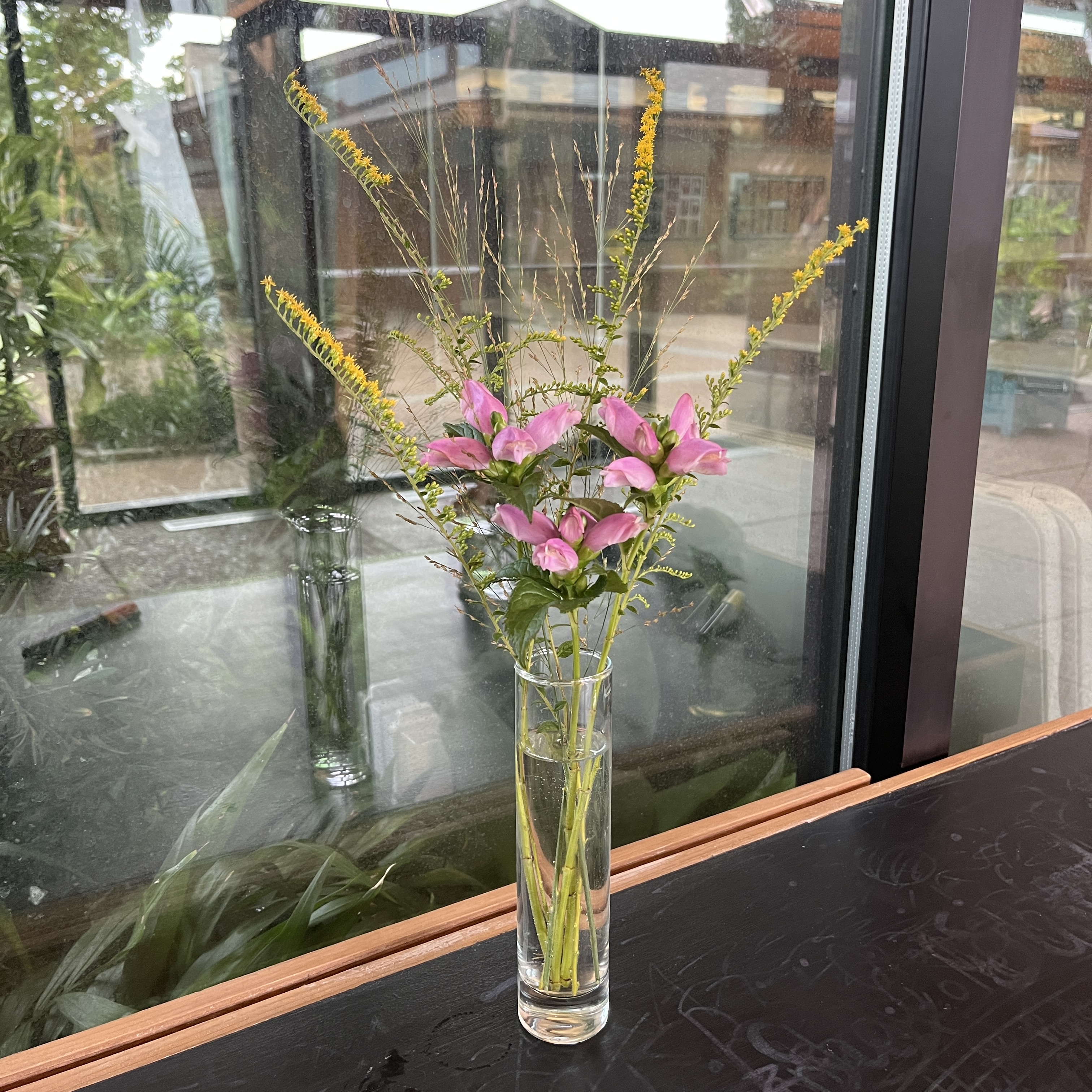Bouquet with grasses and pink flowers.