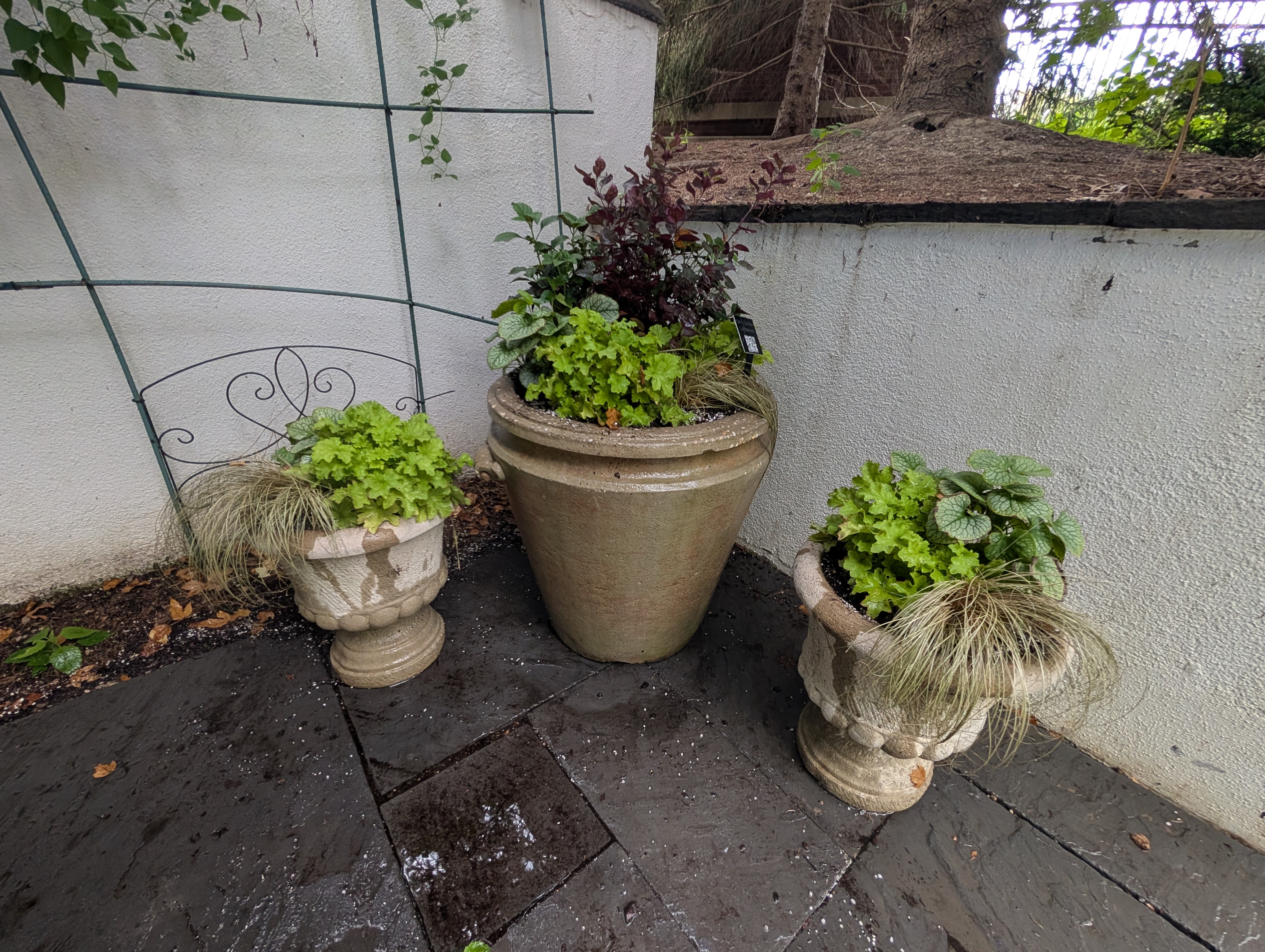 a group of three concrete containers with fall containers