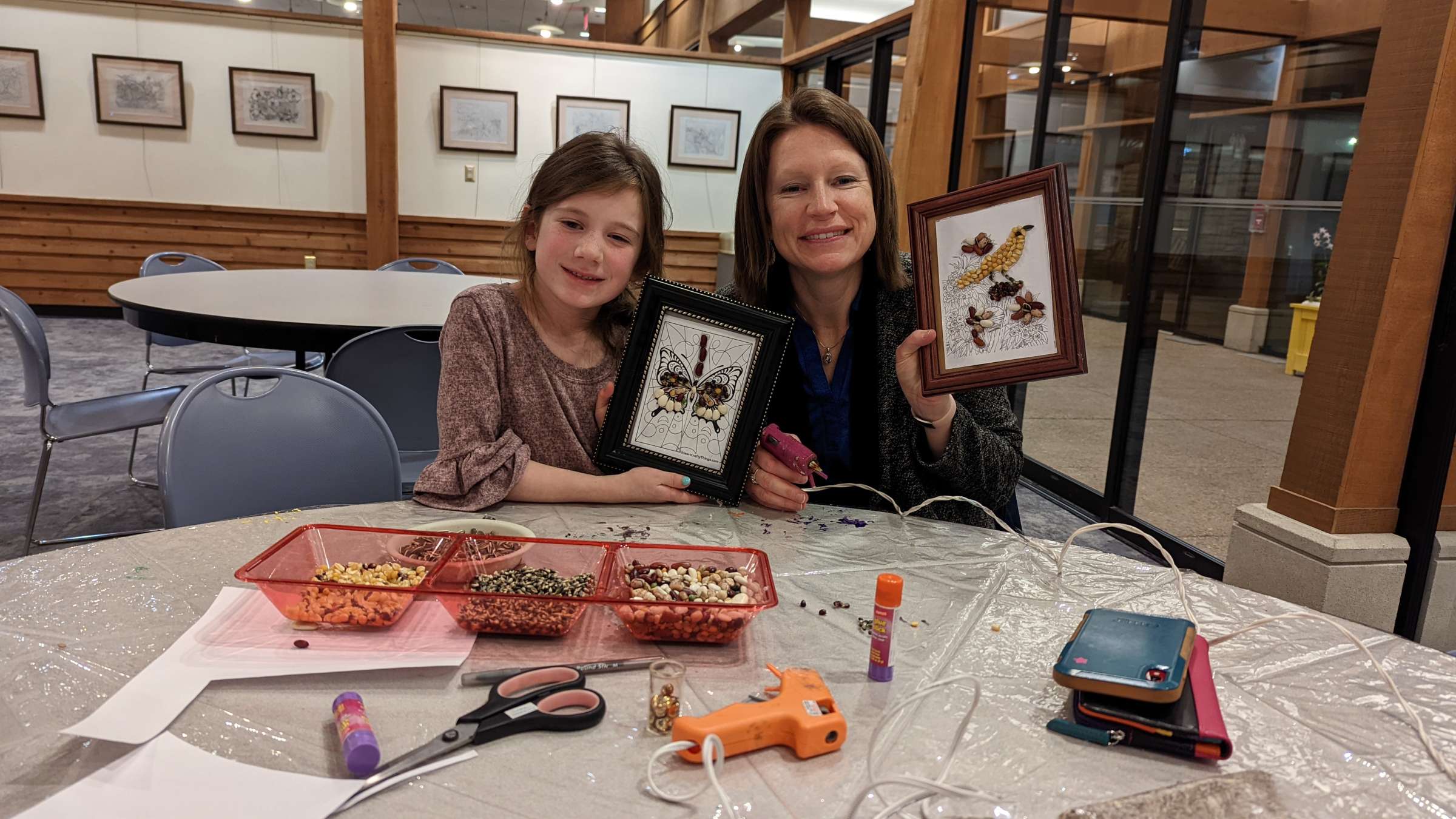 A m other and daughter show off the project made at a Reiman Gardens Maker Night.