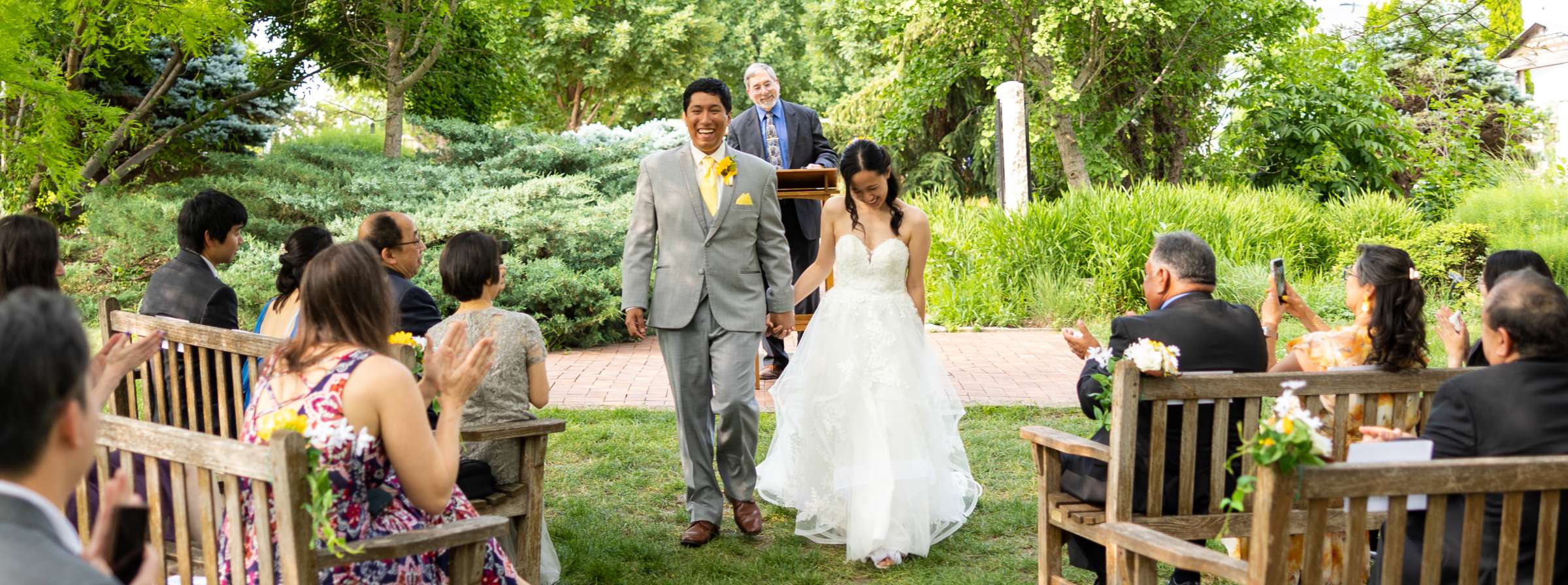 Bride and groom in a garden with guests