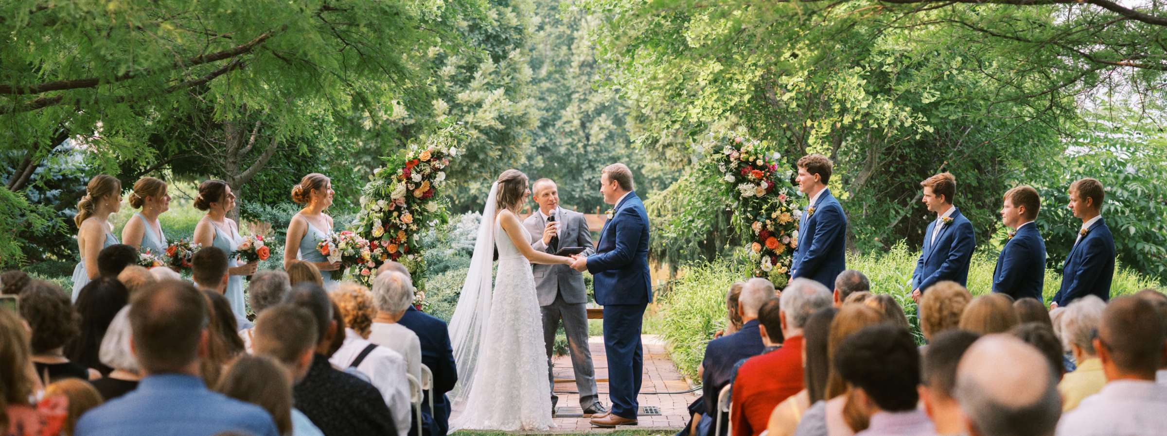 Wedding ceremony in beautiful garden surrounded by cypress trees