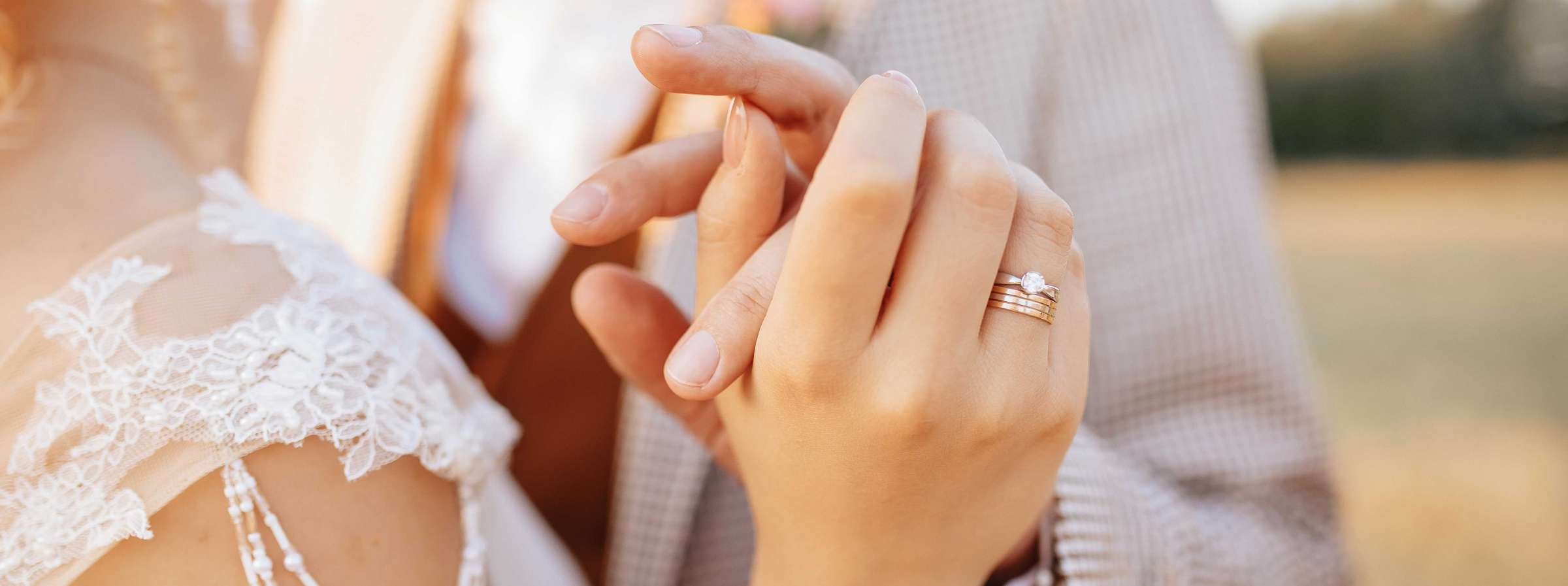 close up of wedding couple holding hands