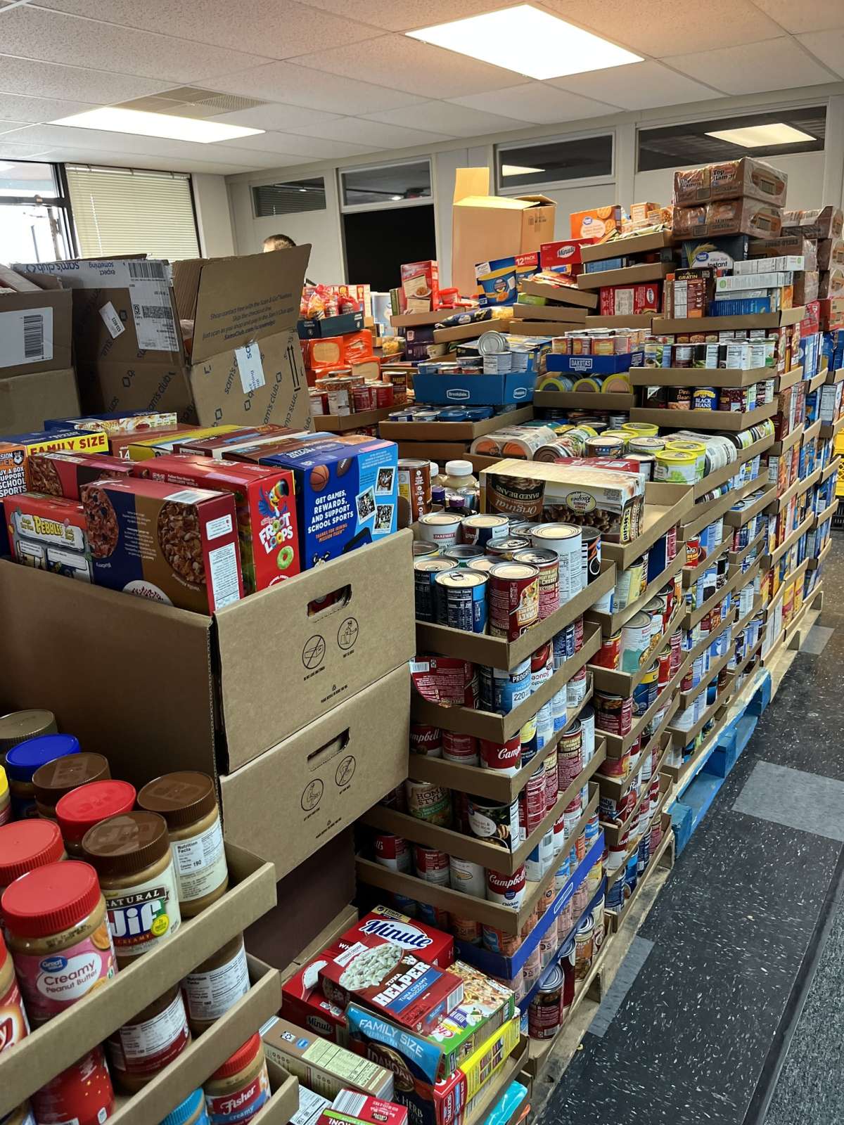 Stacks of donated, non-perishable food in MICA's storage room.