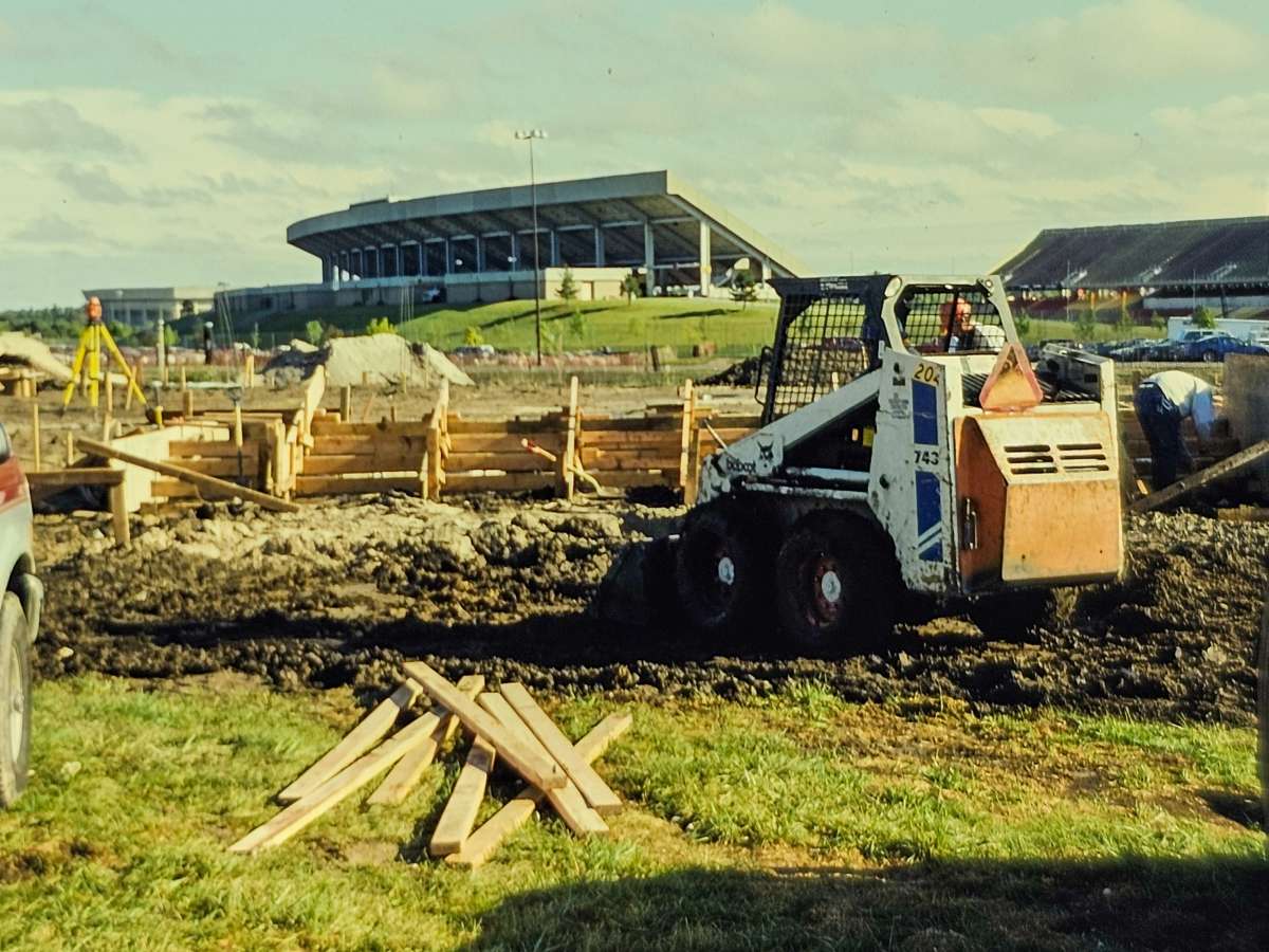 breaking ground for Reiman Gardens in 1995, with the stadium in the background