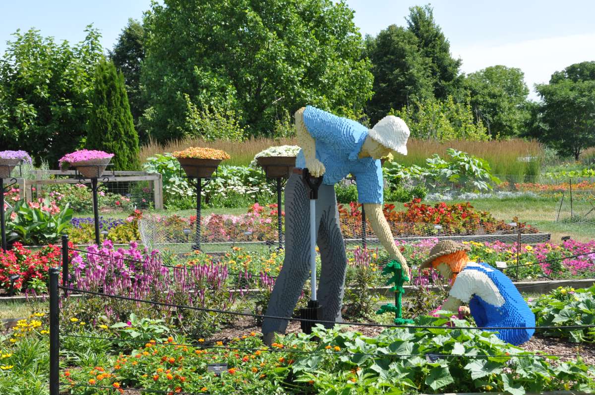 a life size sculpture of two gardeners made from LEGO bricks at Reiman Gardens