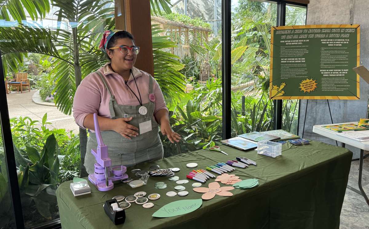 A Science Communication Fellow shares information at Reiman Gardens