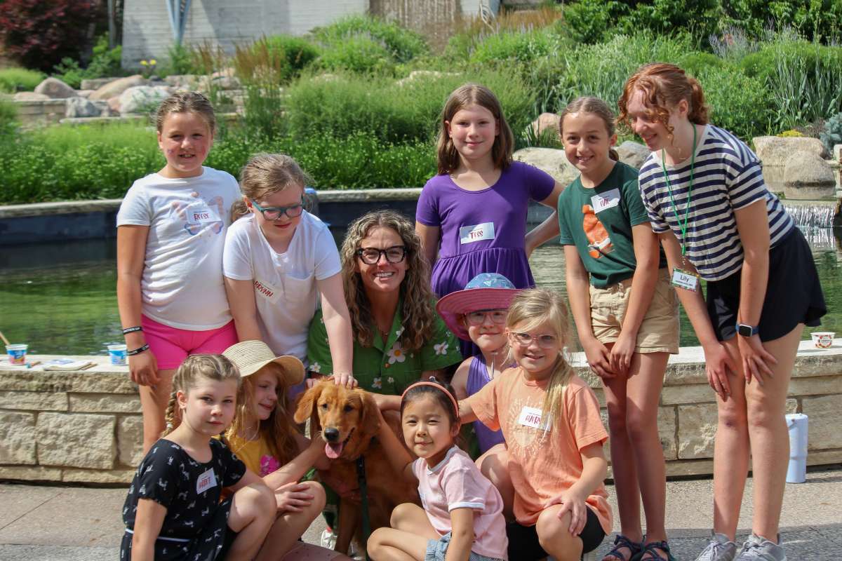 Bookworm campers meeting Dogeared Books owner Amanda L. and her shop dog, Story
