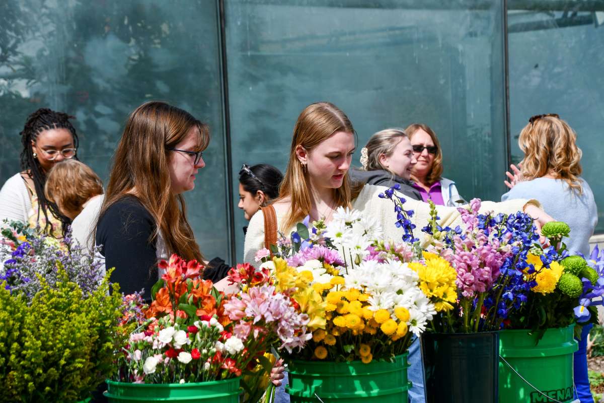 Women selecting flowers at a flower bar