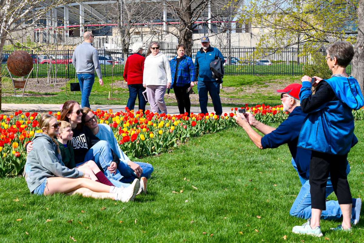 Family having their photo taken in front of a field of tulips