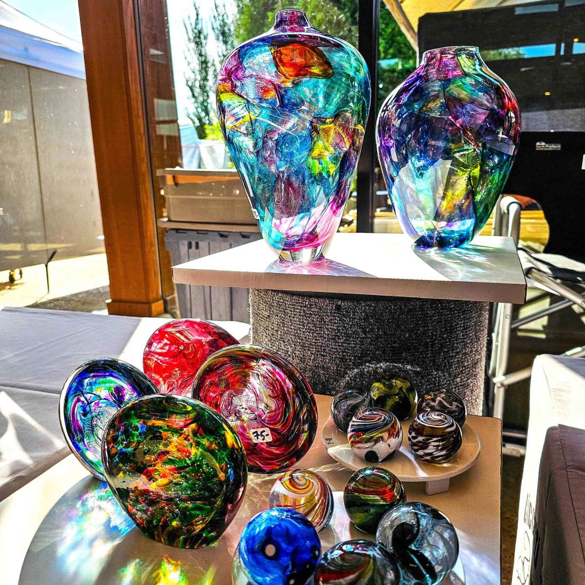 Colorful glass vases displayed in a window