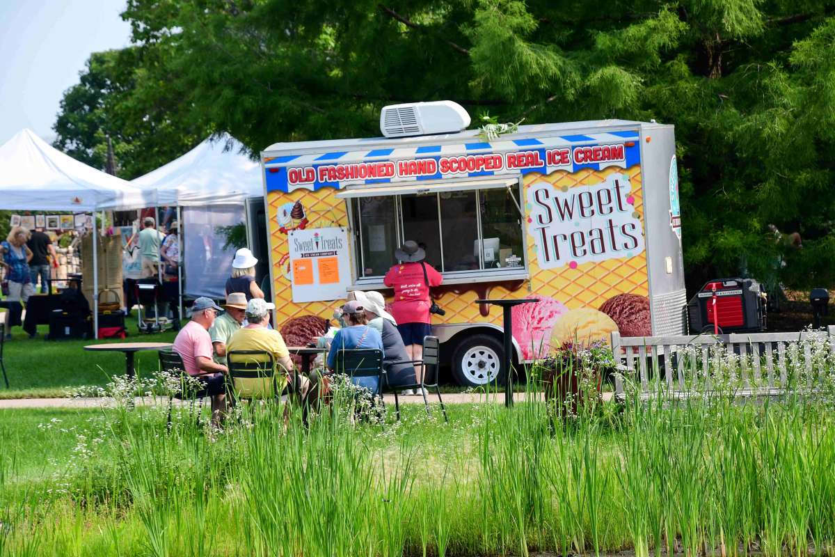An ice cream truck at an outdoor art fair