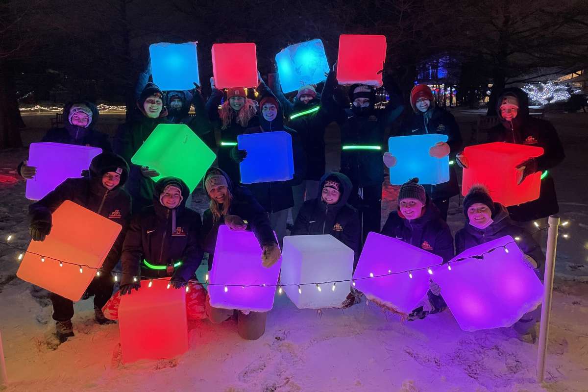 Members of the ISU Swimming and Diving Team pose for a picture while volunteering at Winter Wonderscape