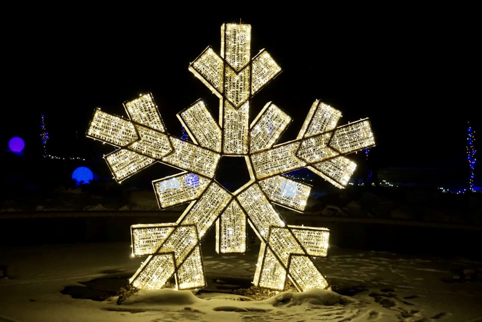 enormous snowflake lit structure shining in the night