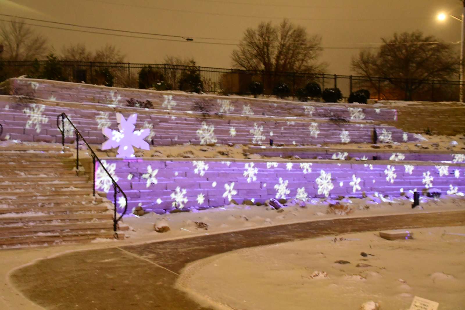 Hillside Garden lit up with snowflake lights.