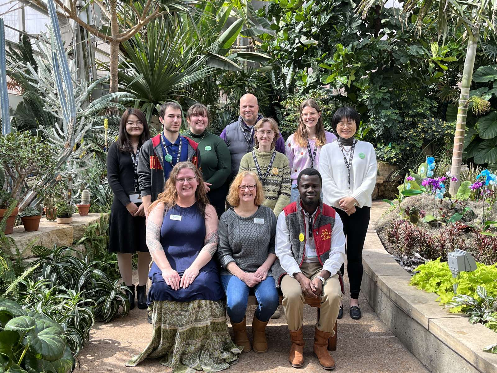 The 2023 Science Communications Fellows pose for a photo in the conservatory.