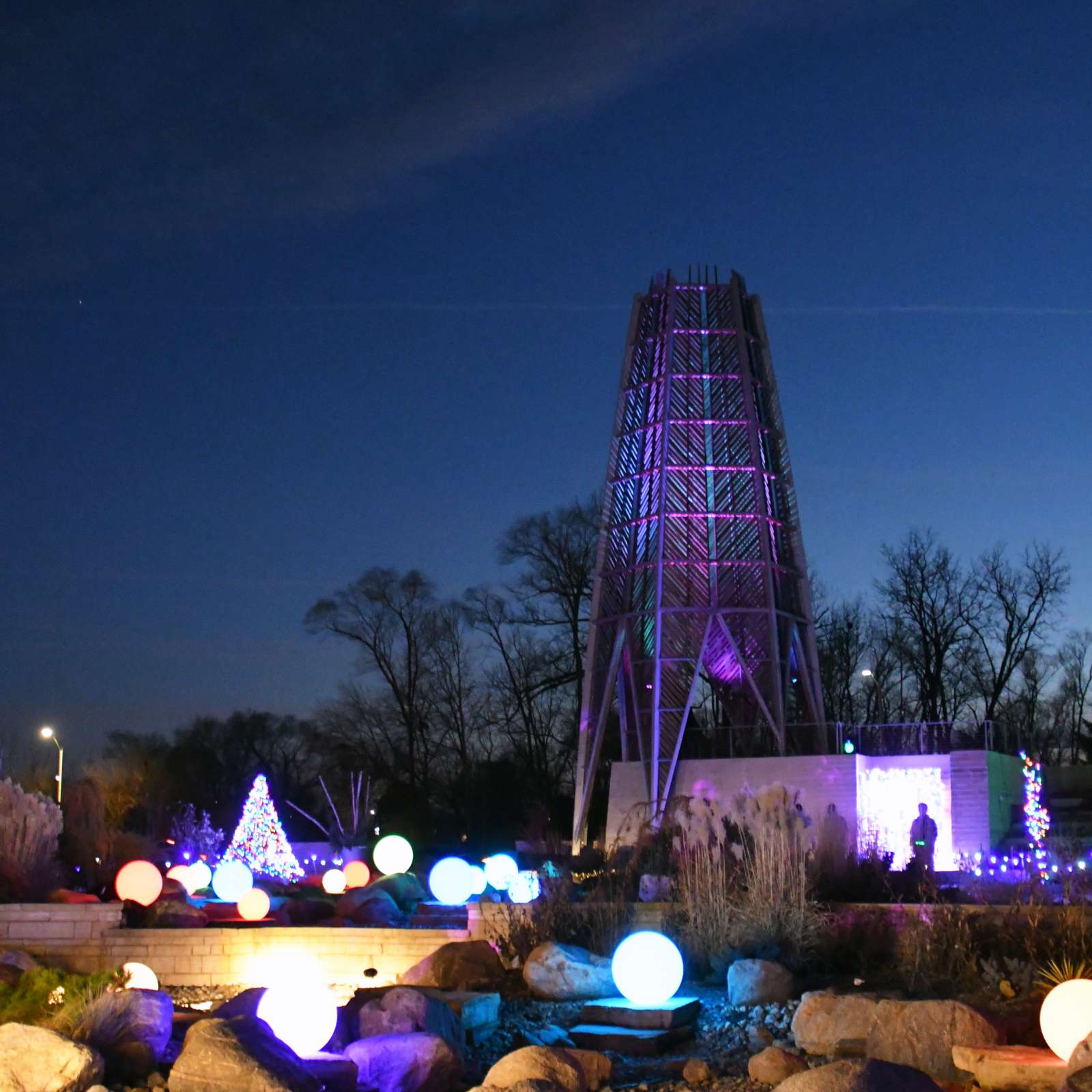 The tower of Sycamore Falls stands tall with lit orbs and shining strands lighting up the night.
