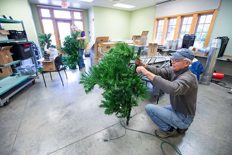 Volunteers help decorate for Winter Wonderscape at Reiman Gardens