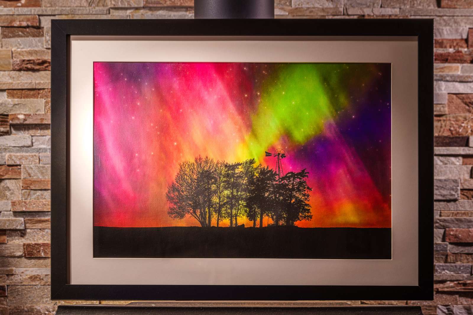 Fine art photograph of sillouetted trees and the Northern Lights