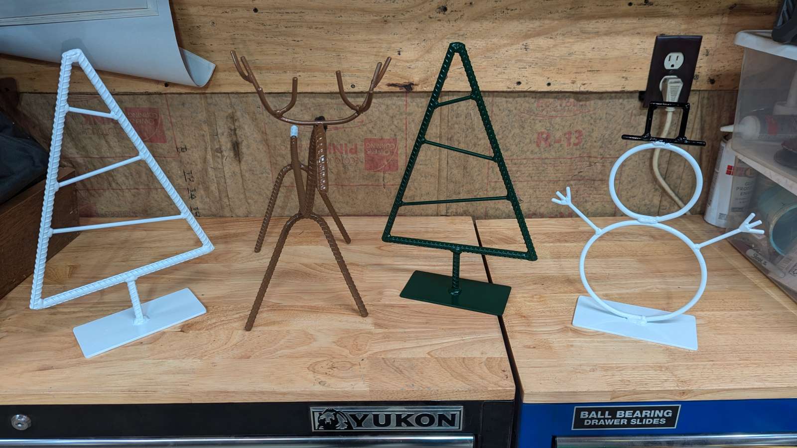 Handcrafted metal Christmas trees, reindeer, and snowmen