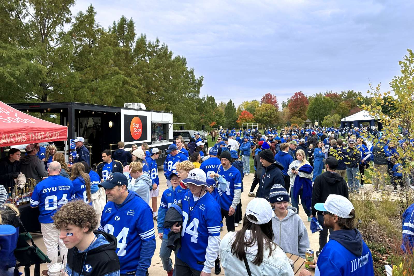 Football fans tailgating at a public garden
