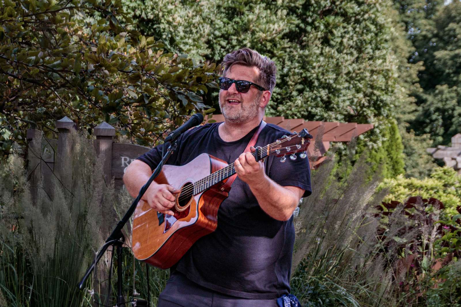 Musician Chad Elliot playing guitar and singing