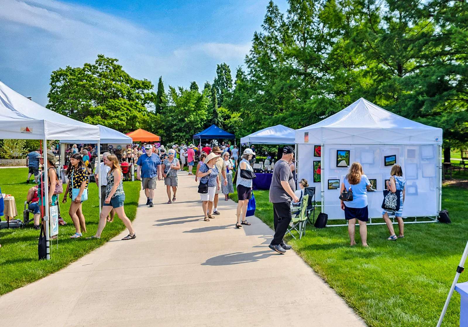 People shopping at an art fair in a park