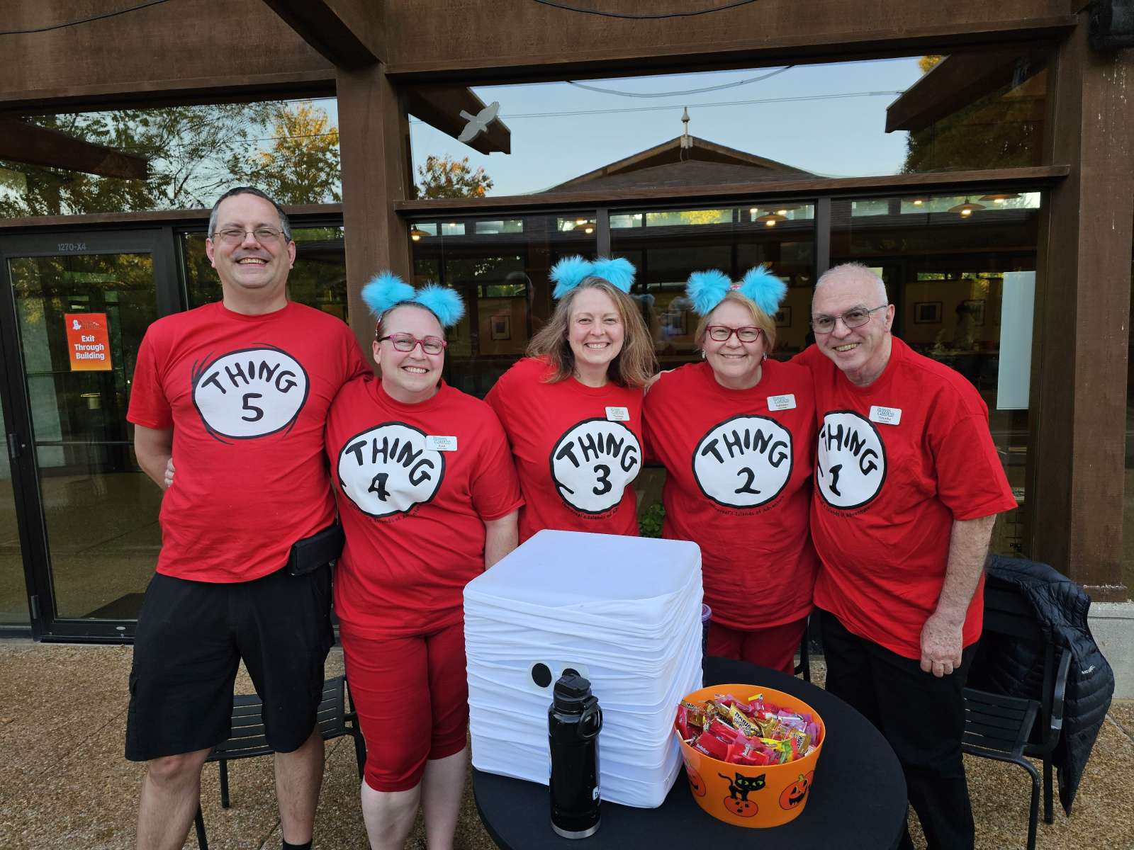 People in costume volunteering at a Halloween event
